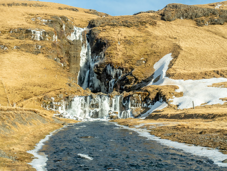 Gluggafoss, large waterfall, in winter season under blue sky in Icelandの写真素材