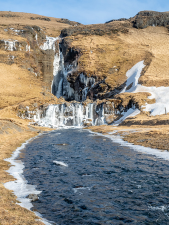 Gluggafoss, large waterfall, in winter season under blue sky in Icelandの写真素材