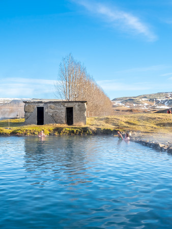 FLUDIR, ICELAND - MARCH 6 : Secret lagoon hot spring, public outdoor warming swimming pool, landmark of small city of Fludir, Iceland, was taken on March 6, 2018.のeditorial素材