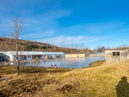 FLUDIR, ICELAND - MARCH 6 : Secret lagoon hot spring, public outdoor warming swimming pool, landmark of small city of Fludir, Iceland, was taken on March 6, 2018.のeditorial素材