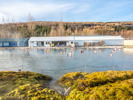 FLUDIR, ICELAND - MARCH 6 : Secret lagoon hot spring, public outdoor warming swimming pool, landmark of small city of Fludir, Iceland, was taken on March 6, 2018.のeditorial素材