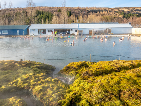 FLUDIR, ICELAND - MARCH 6 : Secret lagoon hot spring, public outdoor warming swimming pool, landmark of small city of Fludir, Iceland, was taken on March 6, 2018.のeditorial素材