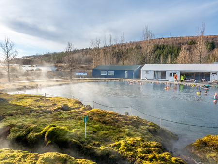 FLUDIR, ICELAND - MARCH 6 : Secret lagoon hot spring, public outdoor warming swimming pool, landmark of small city of Fludir, Iceland, was taken on March 6, 2018.のeditorial素材
