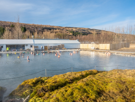 FLUDIR, ICELAND - MARCH 6 : Secret lagoon hot spring, public outdoor warming swimming pool, landmark of small city of Fludir, Iceland, was taken on March 6, 2018.のeditorial素材