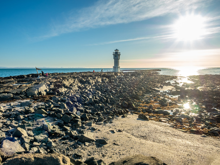 The old inactive Arkranes lighthouse at end of peninsula, was built since 1918, under blue sky, Icelandの写真素材