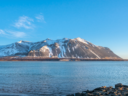 Mountains, sea and coastline view in winter season under blue sky in Icelandの写真素材