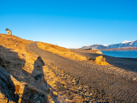 Mountains, sea and coastline view in winter season under blue sky in Icelandの写真素材