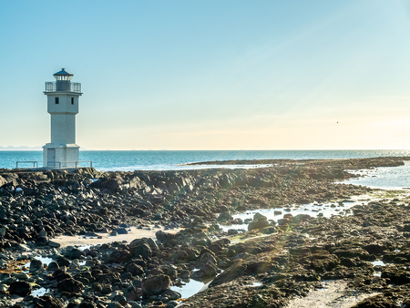The old inactive Arkranes lighthouse at end of peninsula, was built since 1918, under blue sky, Icelandの写真素材