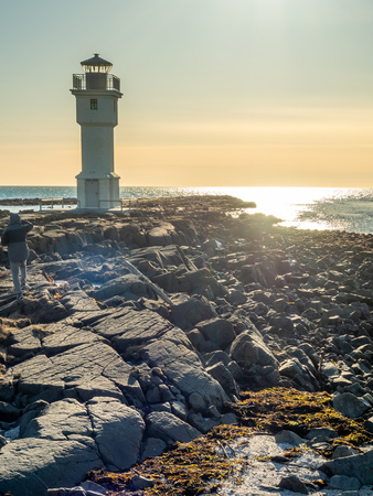 The old inactive Arkranes lighthouse at end of peninsula, was built since 1918, under blue sky, Icelandの写真素材