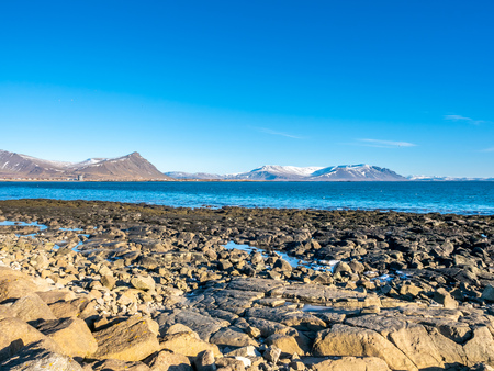 Large stones at Akranes peninsula near the lighthouses under blue sky, Icelandの写真素材