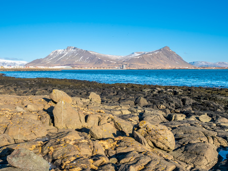 Large stones at Akranes peninsula near the lighthouses under blue sky, Icelandの写真素材