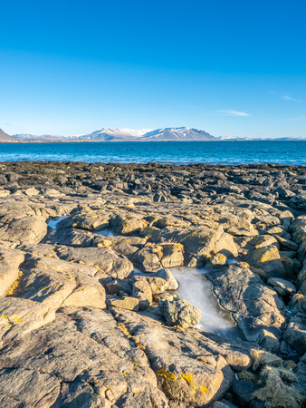 Large stones at Akranes peninsula near the lighthouses under blue sky, Icelandの写真素材