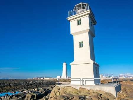 The old inactive Arkranes lighthouse at end of peninsula, was built since 1918, under blue sky, Icelandの写真素材