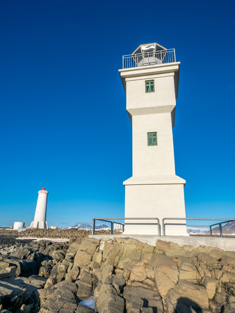 The old inactive Arkranes lighthouse at end of peninsula, was built since 1918, under blue sky, Icelandの写真素材