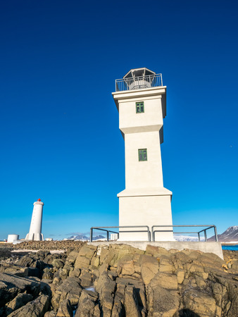The old inactive Arkranes lighthouse at end of peninsula, was built since 1918, under blue sky, Icelandの写真素材