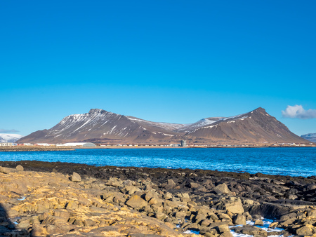 Large stones at Akranes peninsula near the lighthouses under blue sky, Icelandの写真素材