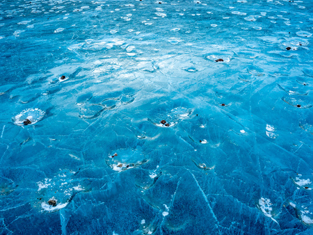 Abstract ice pattern on lake at Kerid crater, old quiet volcano in Iceland, in winter seasonの写真素材