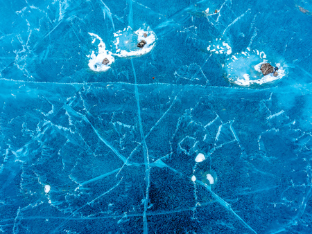 Abstract ice pattern on lake at Kerid crater, old quiet volcano in Iceland, in winter seasonの写真素材