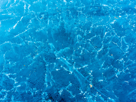 Abstract ice pattern on lake at Kerid crater, old quiet volcano in Iceland, in winter seasonの写真素材