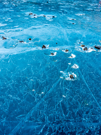 Abstract ice pattern on lake at Kerid crater, old quiet volcano in Iceland, in winter seasonの写真素材