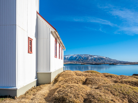 Church on lake Ulfljotsvatn, known as Ulfljotsvatnskirkja, is landmark of southern of Iceland, beautiful viewpoint under clear blue skyの写真素材