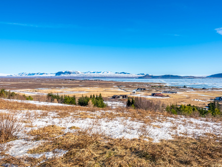 Landscape beautiful view, lake, mountains and field under cloudy blue sky in winter season, Icelandの写真素材