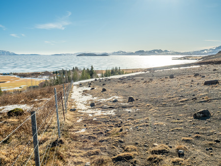 Landscape beautiful view, lake, mountains and field under cloudy blue sky in winter season, Icelandの写真素材