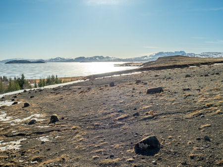 Landscape beautiful view, lake, mountains and field under cloudy blue sky in winter season, Icelandの写真素材