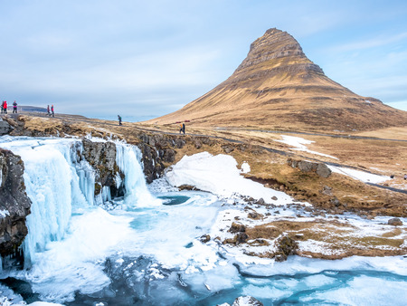 Viewpoint of Kirkjufell mountain and Kirkjufellfoss waterfall, the most popular photograph point in Iceland, cold and freeze water in winter seasonの写真素材