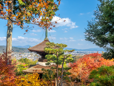 Arashiyama cityscape viewpoint with autumn tree forest under cloudy blue sky with mountains in background and landmark Japanese style pagoda, Japanのeditorial素材