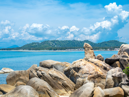 Hin ta, grandpa rock, giant stone  at beach in Samui island, Thailand, under cloudy blue skyの写真素材