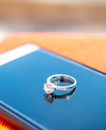 Diamond wedding ring reflect on glassの写真素材