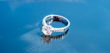 Diamond wedding ring reflect on glassの写真素材