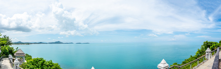Panorama view of architecture at landmark viewpoint with seascape view of Samui island, Thailand, under cloudy blue skyの写真素材