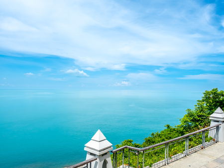 Architecture at landmark viewpoint with seascape view of Samui island, Thailand, under cloudy blue skyの写真素材