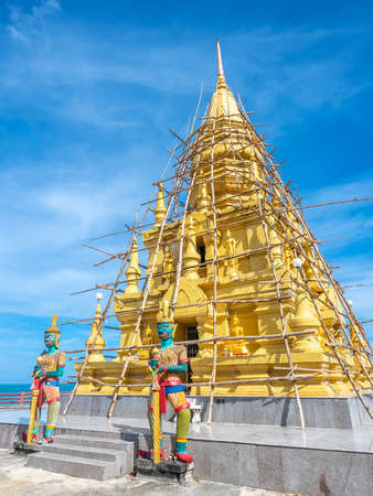 Phra That Laem Sor temple pagoda at sea side under cloudy blue sky in summer season, under construction at Samui island, Thailandの写真素材