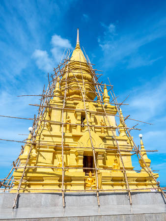 Phra That Laem Sor temple pagoda at sea side under cloudy blue sky in summer season, under construction at Samui island, Thailandの写真素材