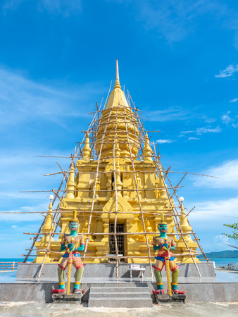 Phra That Laem Sor temple pagoda at sea side under cloudy blue sky in summer season, under construction at Samui island, Thailandの写真素材