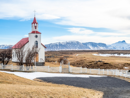 Helgafell church, classic architecture building of iceland church, on hill in winter season under cloudy blue skyの写真素材