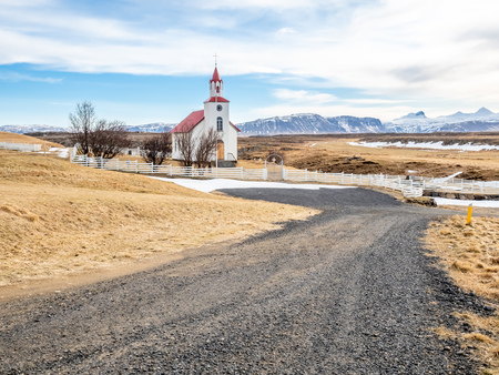 Helgafell church, classic architecture building of iceland church, on hill in winter season under cloudy blue skyの写真素材