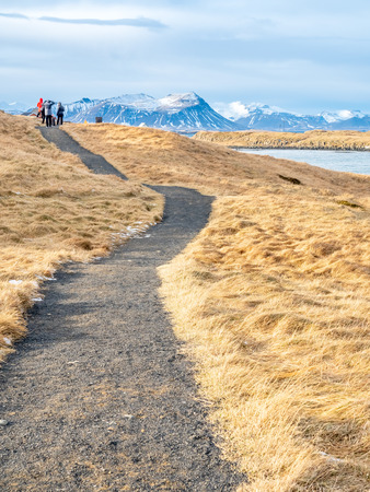 Seascape view with moutain under cloudy blue sky from Stykissholmur lighthouse hill in winter season, Icelandの写真素材