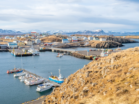 STYKKISHOLMUR, ICELAND - MARCH 9 : Commercial harbor with ships and boats in bays with cityscape view at Stykkisholmur town in Iceland, was taken on March 9, 2018.のeditorial素材