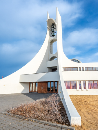 Stykkisholmur church on hill at center of town under cloudy blue sky, Icelandの写真素材