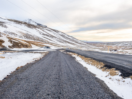 Landscape view with snow in winter season under cloudy sky along road side in Icelandの写真素材
