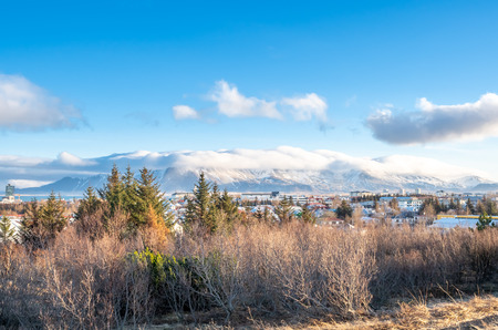 Cityscape of Reykjavik, capital city of Iceland, under cloudy blue sky from Perlan Observatory deck viewpointの写真素材