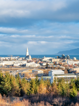 Cityscape of Reykjavik, capital city of Iceland, under cloudy blue sky from Perlan Observatory deck viewpointのeditorial素材
