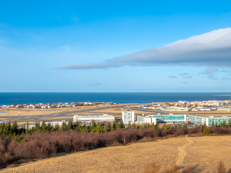 Cityscape of Reykjavik, capital city of Iceland, under cloudy blue sky from Perlan Observatory deck viewpointの写真素材