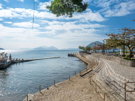 Coastline along Repulse bay at Kwun Yam shrine under blue sky, Hong Kong, Chinaの写真素材