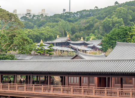 HONG KONG, CHINA - JANUARY 20 : Outdoor garden with tree, pavilion and buildings with pond with skyscraper buildings in background, Hong Kong, China, on January 20, 2018.のeditorial素材