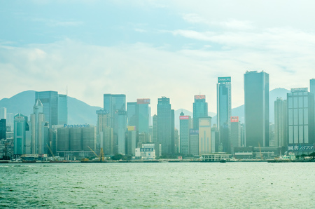HONG KONG, CHINA - JANUARY 20 : Landmark skyscraper buildings at Victoria harbor with daylight mist, Hong Kong, China, on January 20, 2018.のeditorial素材